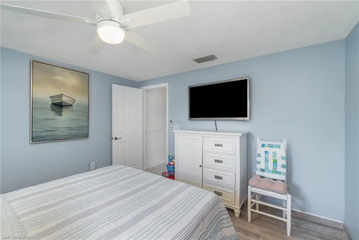 Bedroom featuring wood-type flooring and ceiling fan