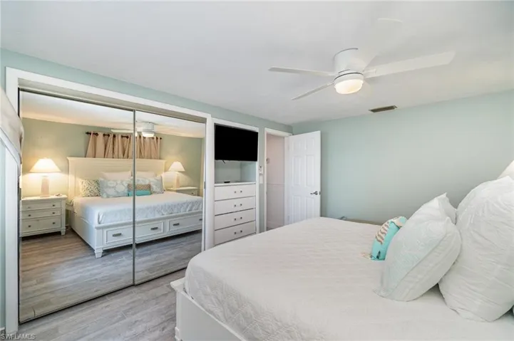 Bedroom with a closet, light wood-type flooring, and ceiling fan