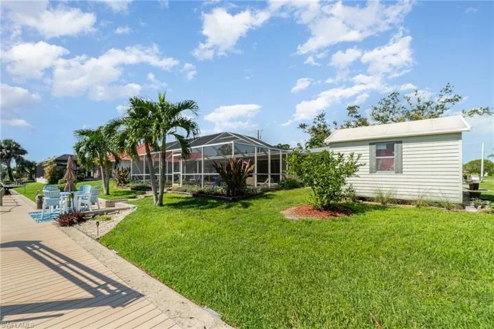 View of yard featuring glass enclosure