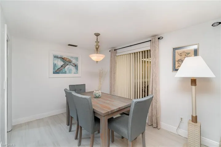 Dining room with light hardwood / wood-style flooring