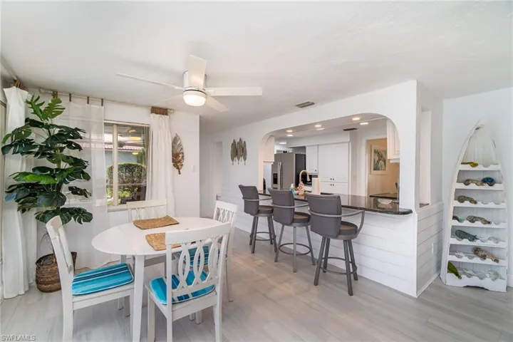 Dining area with light hardwood / wood-style floors and ceiling fan