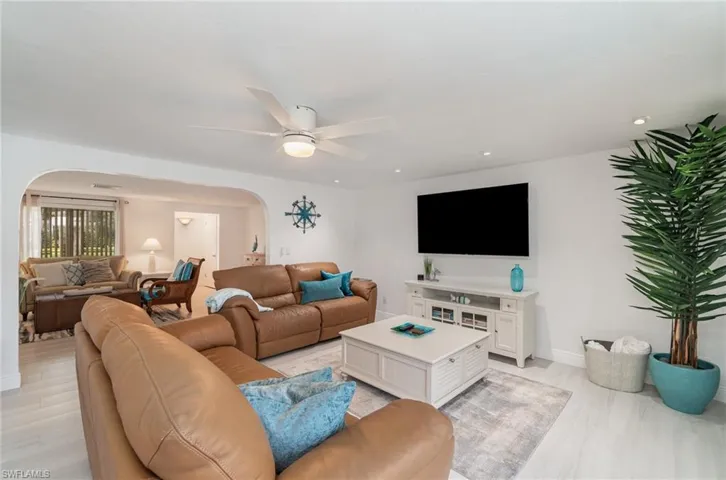 Living room featuring ceiling fan and light wood-type flooring