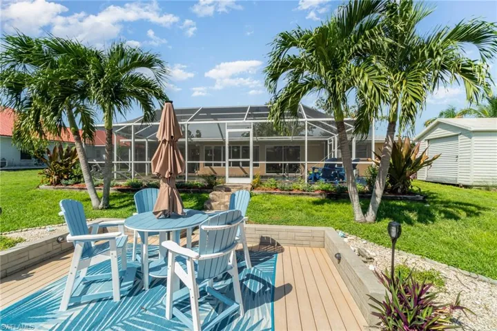 Wooden terrace with a yard, a storage shed, and a lanai
