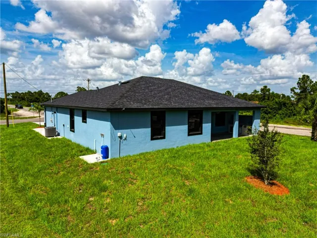 View of home's exterior with a lawn and central air condition unit