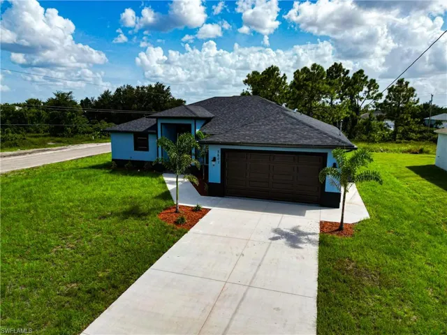 Ranch-style house with a front lawn and a garage