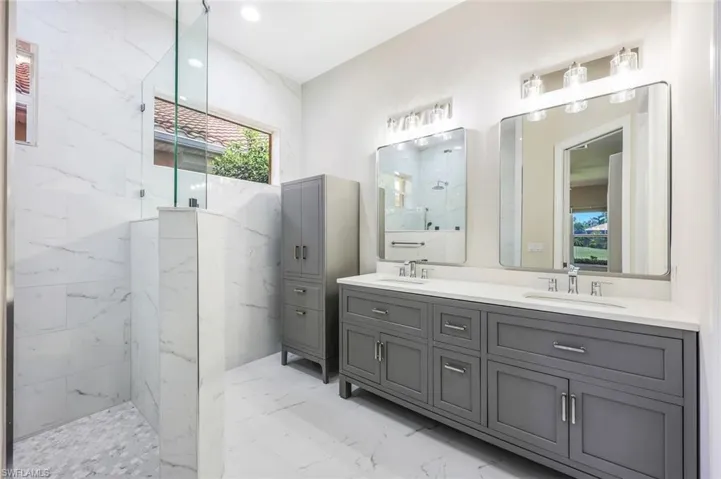 Bathroom with tile patterned flooring and dual bowl vanity