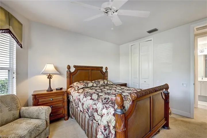 bedroom featuring ceiling fan, a closet, and ensuite bathroom