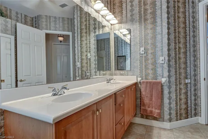 Bathroom with tile patterned floors and vanity