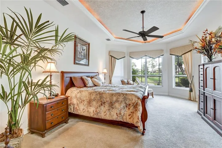 Main Bedroom, a textured ceiling, a raised ceiling, and ceiling fan