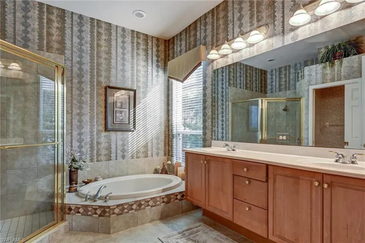 Bathroom featuring vanity, tile patterned floors, and independent shower and bath