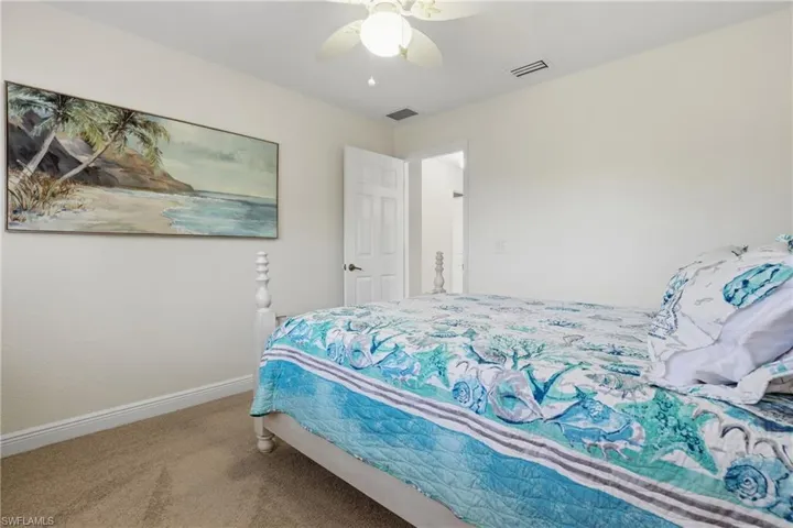 Carpeted bedroom with baseboards and ceiling fan