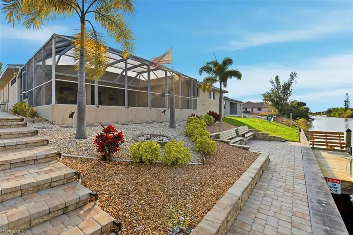 View of property exterior featuring glass enclosure and a sunroom