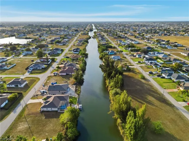 Aerial overview of property's location featuring nearby suburban area and a large body of water