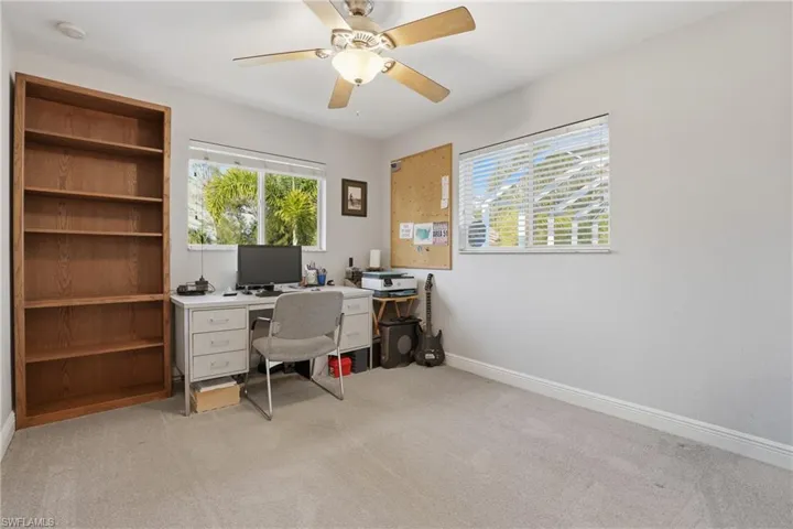 Office area featuring plenty of natural light, light colored carpet, and ceiling fan