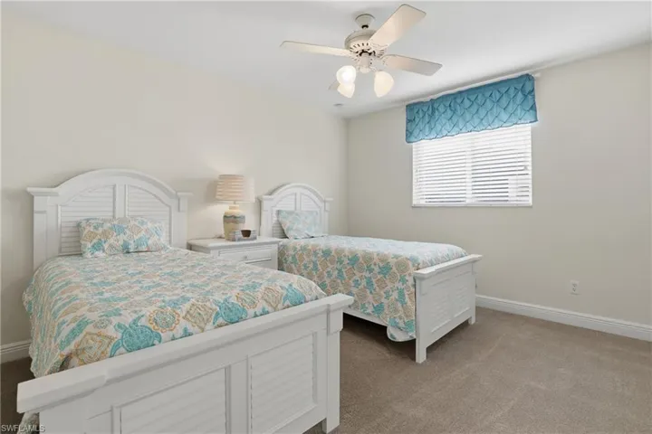 Bedroom featuring light colored carpet and a ceiling fan