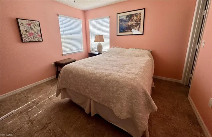 Bedroom featuring a textured wall and a textured ceiling