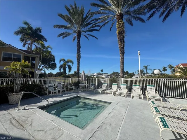 View of pool featuring a patio area and a hot tub