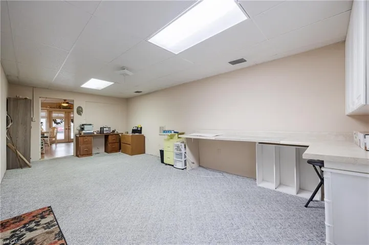 Carpeted office with a paneled ceiling