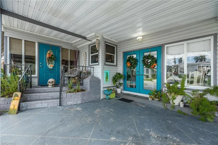 Entrance to property featuring covered porch