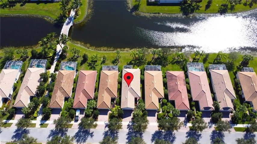 Birds eye view of property with a water view
