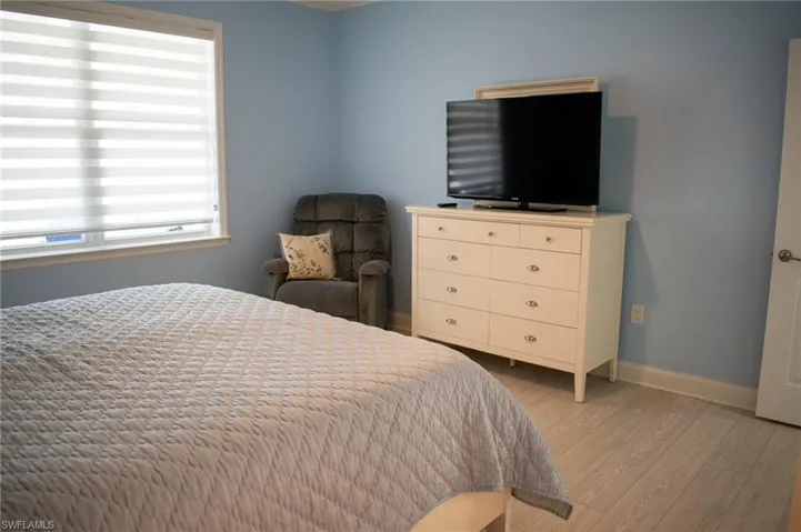 Bedroom with light hardwood / wood-style flooring