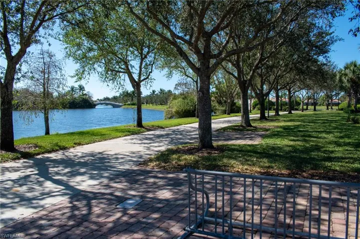 View of home's community featuring a yard and a water view