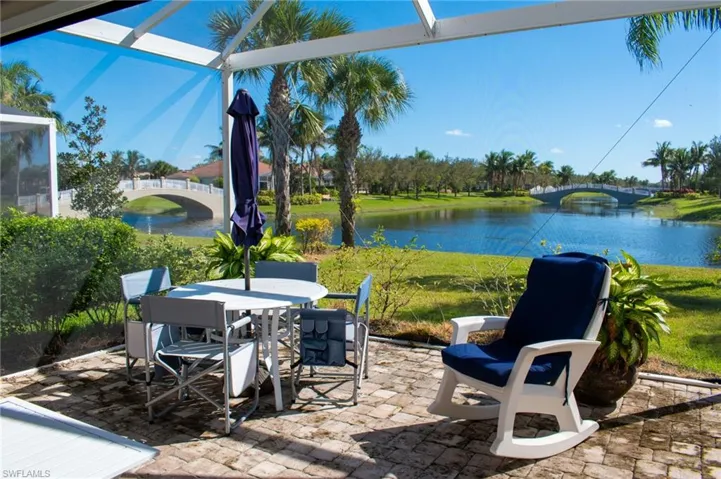 View of patio / terrace featuring a water view and a lanai