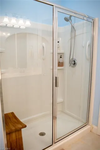 Bathroom with tile patterned floors and an enclosed shower