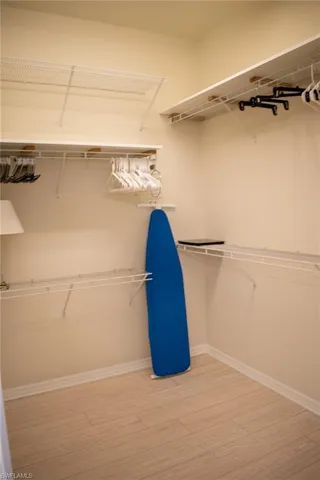 Walk in closet featuring hardwood / wood-style floors