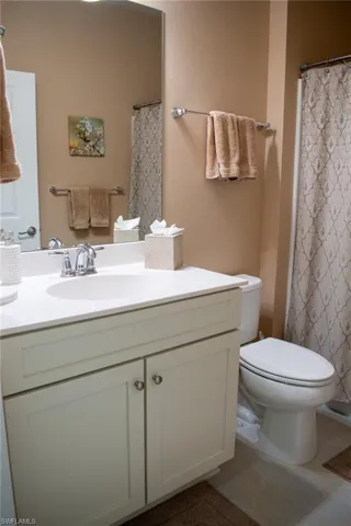 Bathroom with tile patterned flooring, vanity, and toilet