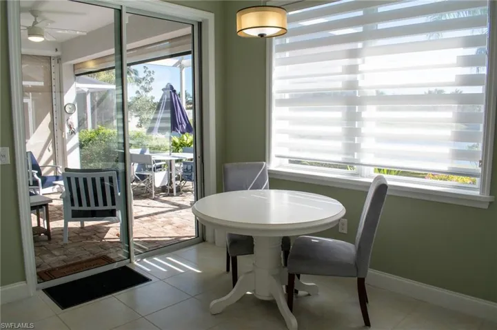 Dining area with ceiling fan and light tile patterned floors