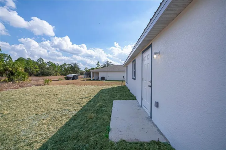 View of grassy yard with a patio
