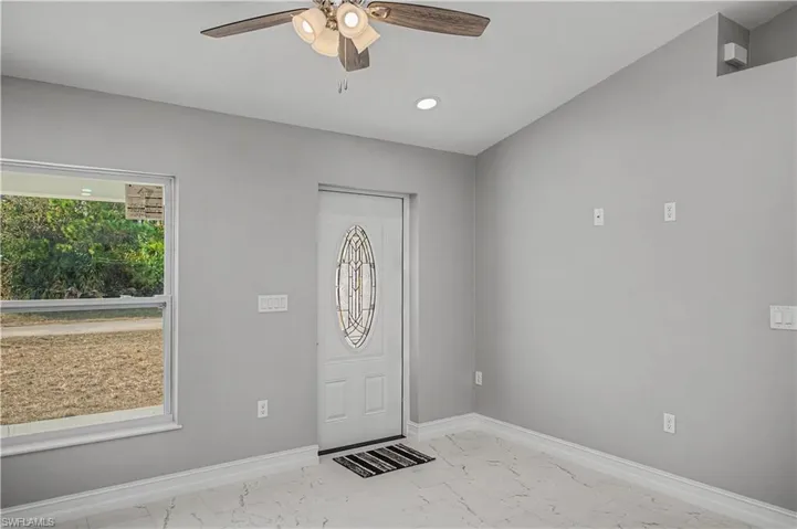Entrance foyer featuring light marble finish floors, ceiling fan, and recessed lighting
