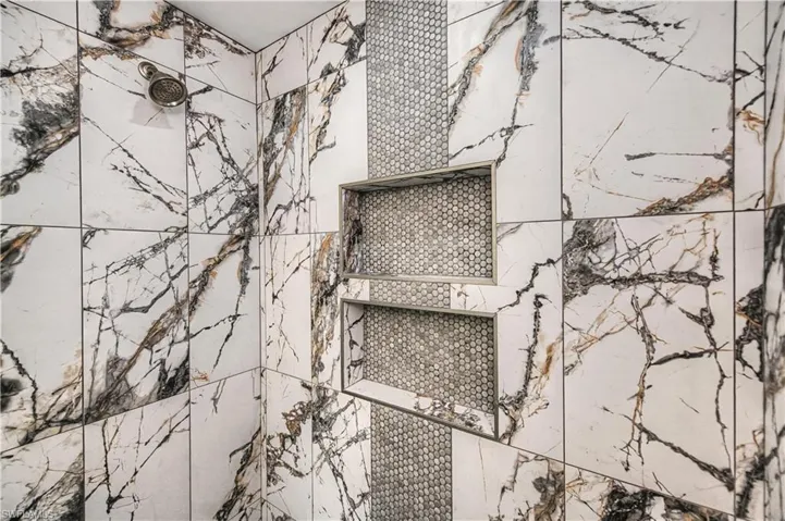 Bathroom view of a marble finish shower