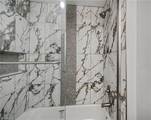 Full bath featuring enclosed tub / shower combo