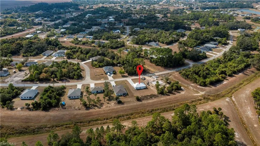 Aerial overview of property's location with a tree filled landscape