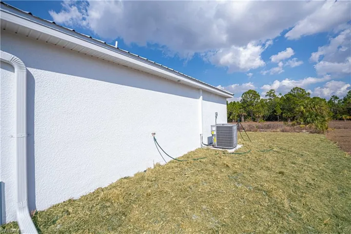 View of home's exterior with a yard and stucco siding