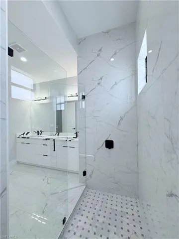 Bathroom with a tile shower and vanity