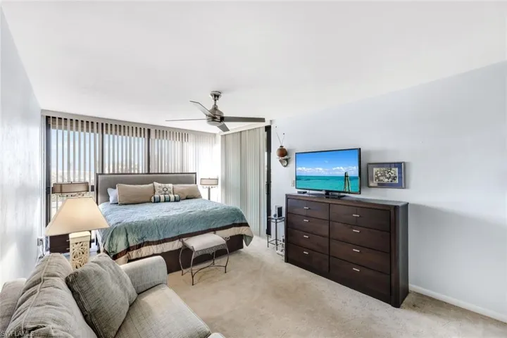Bedroom featuring light carpet and ceiling fan