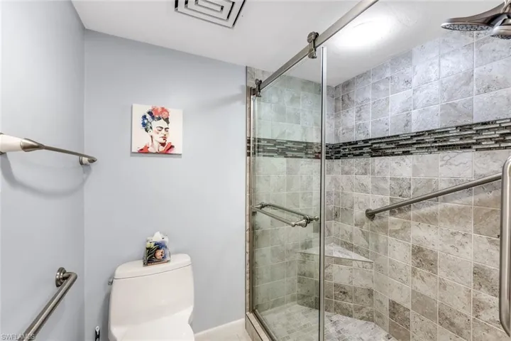 Full bathroom featuring a shower stall