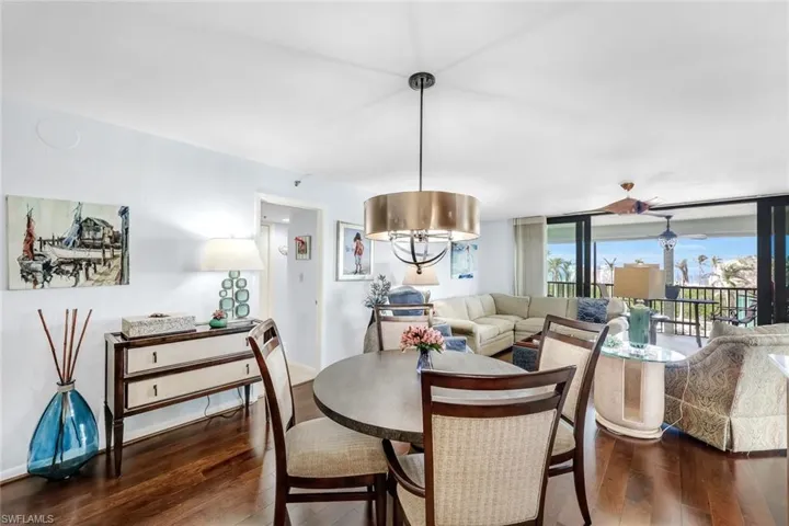 Dining area featuring dark wood-type flooring and a chandelier