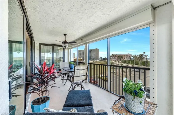 Sunroom featuring a ceiling fan