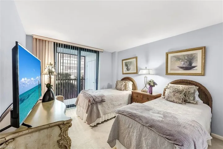 Bedroom with access to exterior, carpet, and floor to ceiling windows