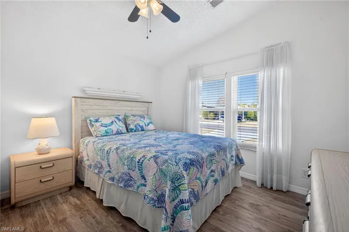 Bedroom with dark wood-style flooring and ceiling fan
