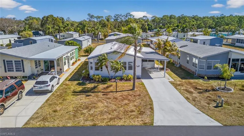 Aerial view of residential area featuring a tree filled landscape