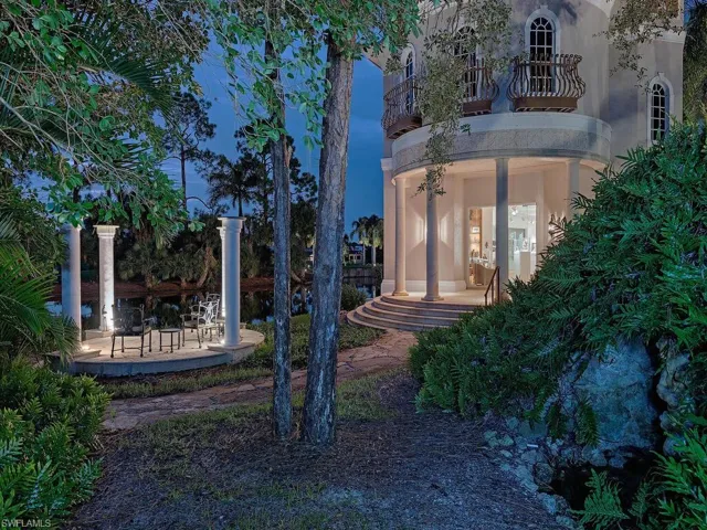 Yard at dusk featuring a patio area and a balcony