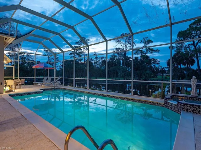 View of swimming pool featuring a lanai and a patio