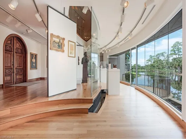 Hallway with a water view and light hardwood / wood-style floors