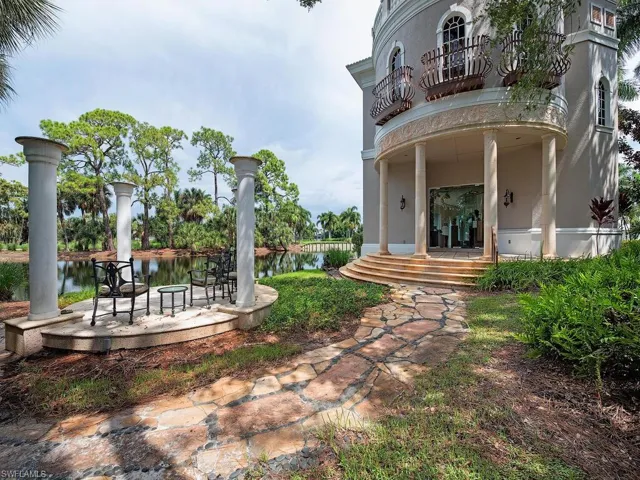 View of yard featuring a water view, a balcony, and a patio