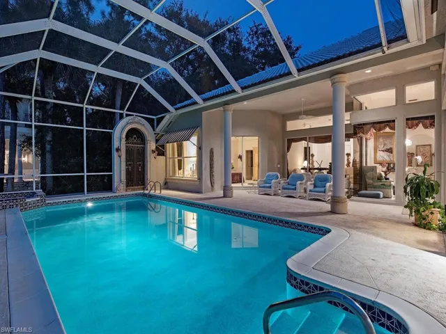 View of swimming pool featuring ceiling fan, a lanai, and a patio